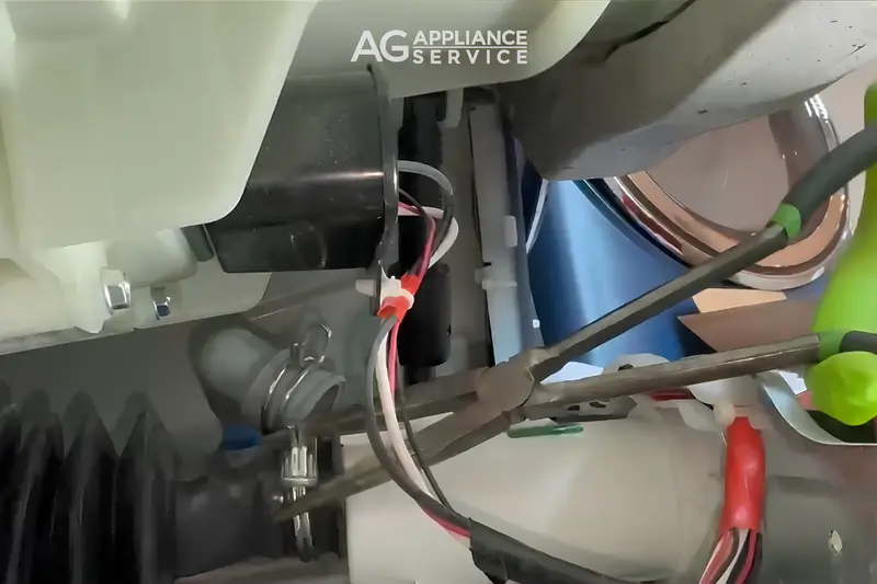 GE washer internal drain components being serviced by AG Appliance Service