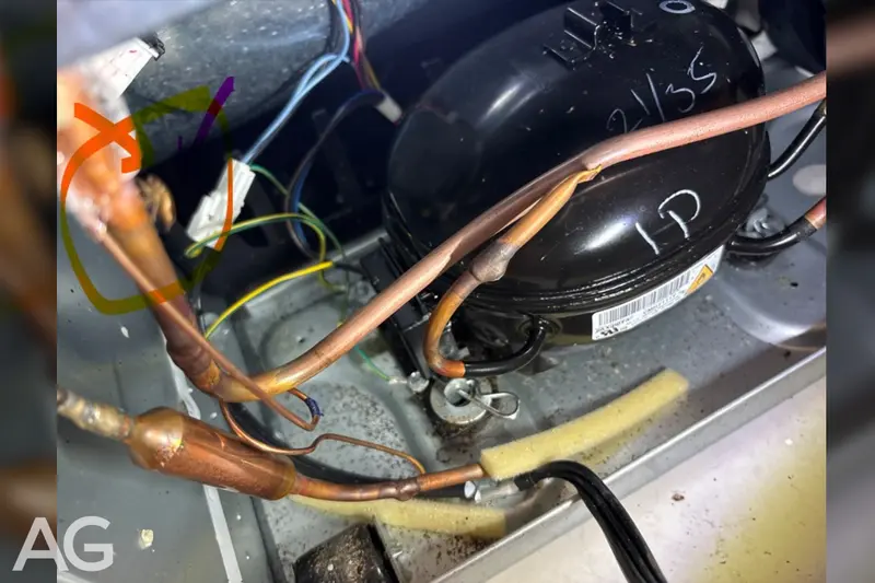 Compressor and refrigerant lines showing damage from an improperly installed outdoor refrigerator