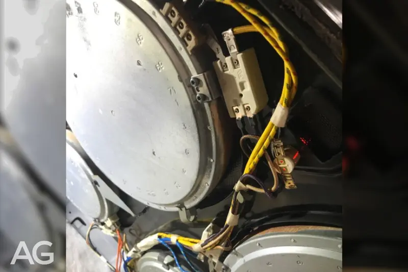 Cooktop element and connected components beneath the glass, where faulty sensors or a shorted switch can cause the red hot-surface light to stay on